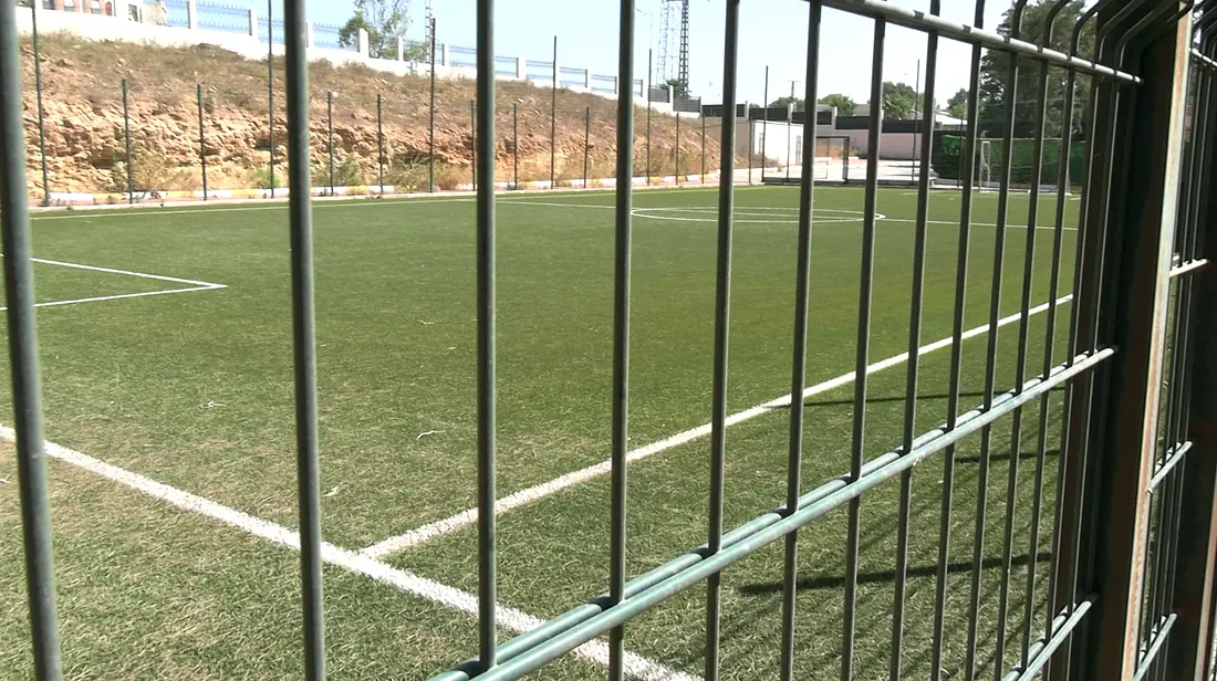 Artificial-turf football pitch seen through the fence