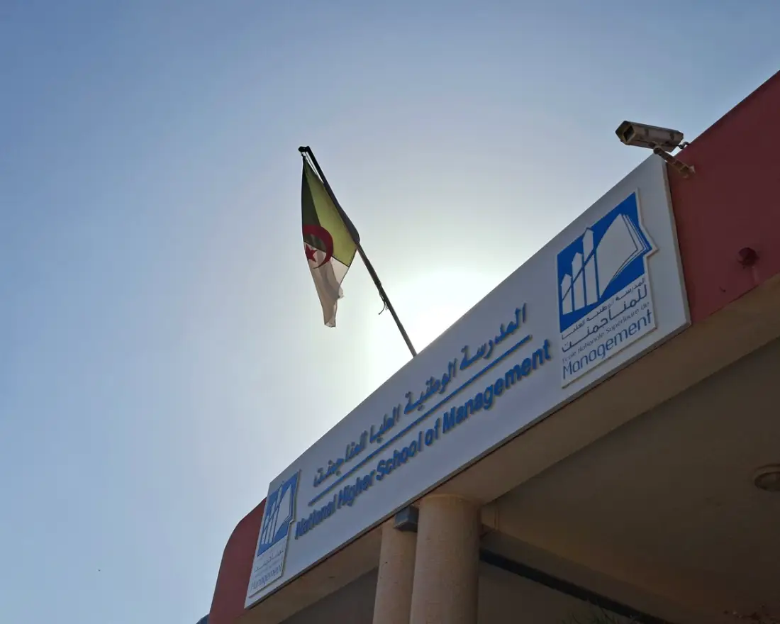 The School’s sign and the national flag above the entrance